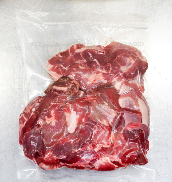 Fresh raw red meat vacuum-sealed in plastic