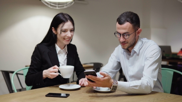 Business Man and Woman During Meeting with Smartphone