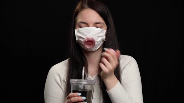 Woman with Handmade Protective Mask on Black Background. alt