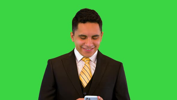 Adult Hispanic Businessman in Suit and Tie Texting in Mobile Phone Messenger App with Happy Smile on