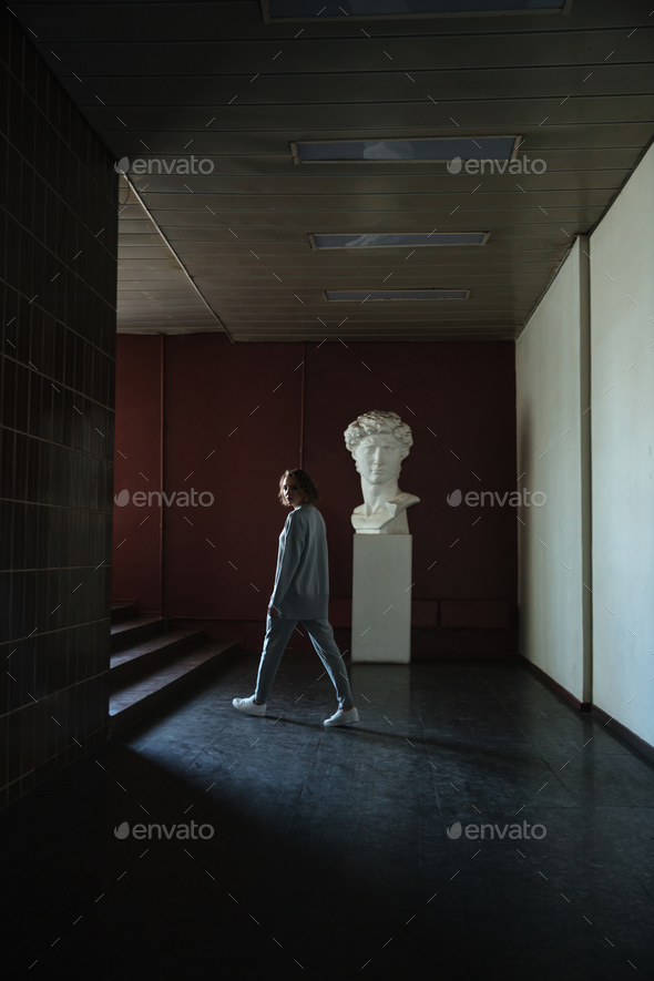 Young woman walking in museum