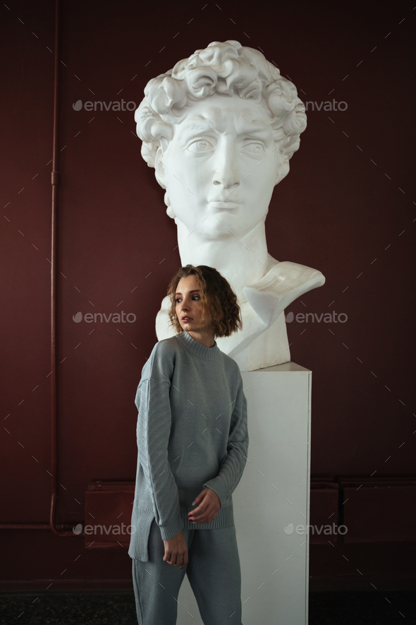Woman standing near bust