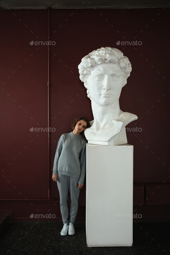 Woman standing near bust