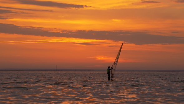 Man Learning How To Windsurf at Sunset