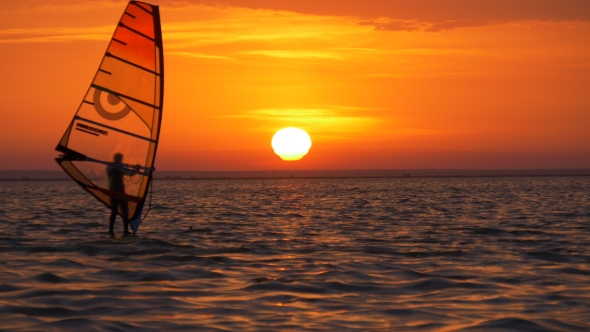 Sun Shines Through Sail of Windsurf