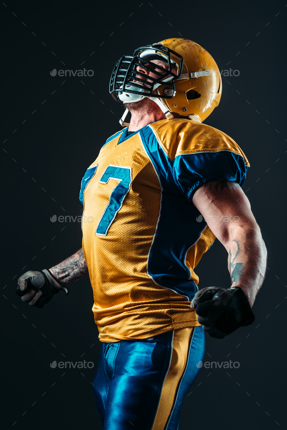 American football player in uniform and helmet - Stock Photo - Images