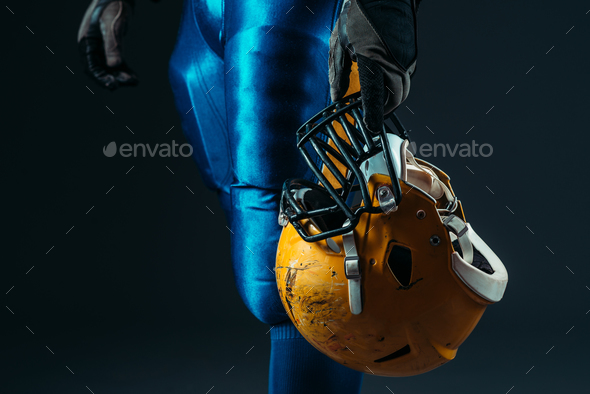 Male person in uniform with football helmet - Stock Photo - Images