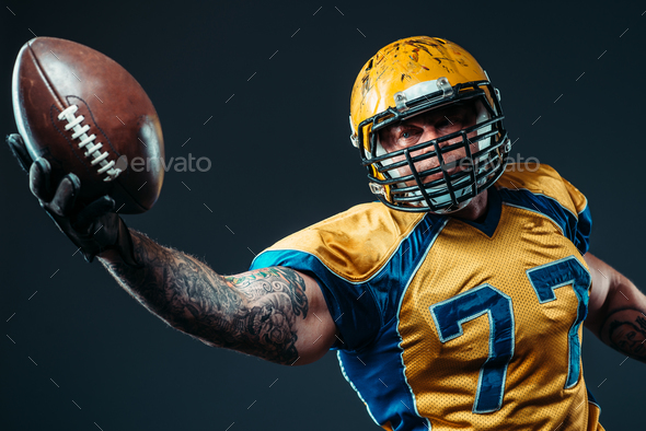 American football offensive player with ball - Stock Photo - Images