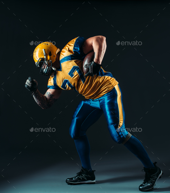 American football offensive player with ball - Stock Photo - Images
