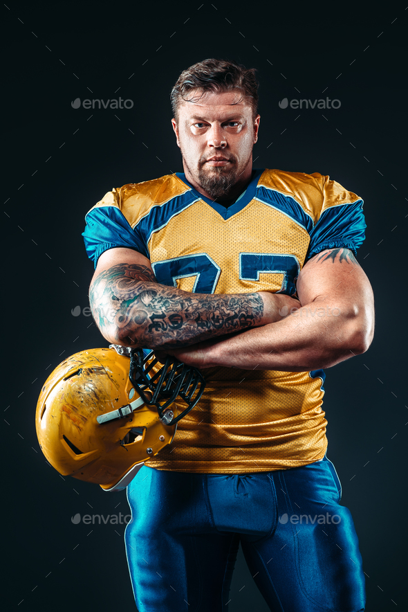American football player with helmet in hand - Stock Photo - Images