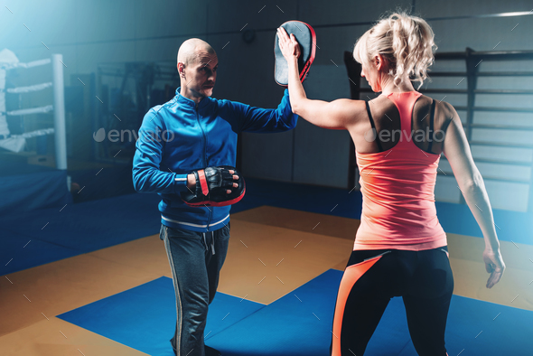 Womens self-defense workout with personal trainer Stock Photo by NomadSoul1