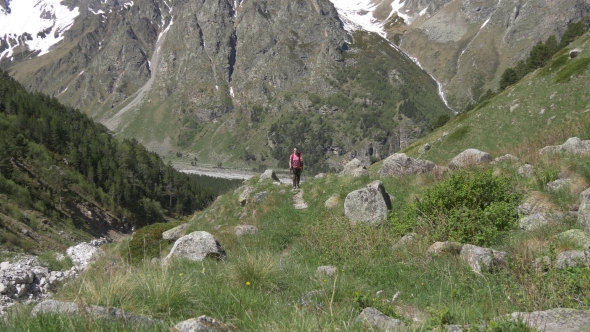 Tourist Walks Up on Beautiful Mountain