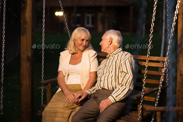 Couple sitting on porch swing