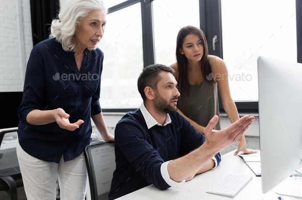 Group of business people discussing financial plan at the table in an office