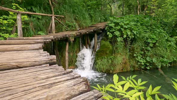 Plitvice Lakes National Park, Croatia. Waterfall Flowing Into Lake Under Wooden Boardwalk Among alt