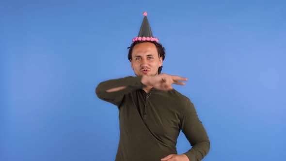 Man in Party Hat and Khaki Colored Shirt alt