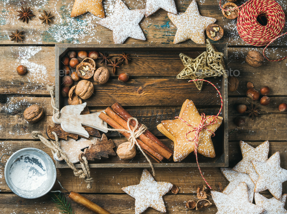 Wooden tray with cookies, decorative angels and stars, cinnamon, nuts - Stock Photo - Images