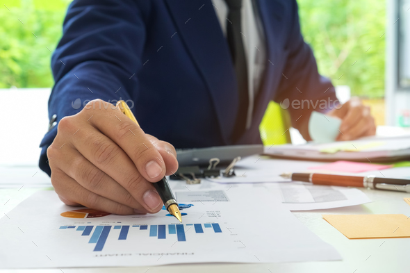 Businessmen are analyzing graph data and taking notes on a flip - Stock Photo - Images