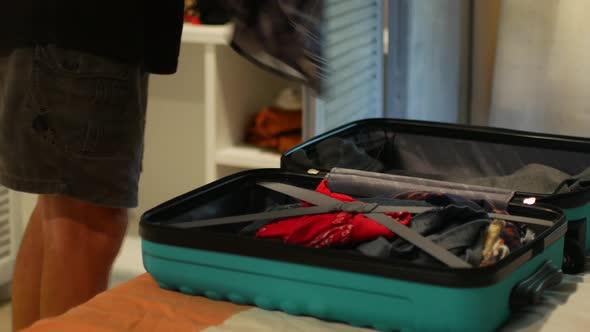 Packing Things From the Closet Into a Suitcase