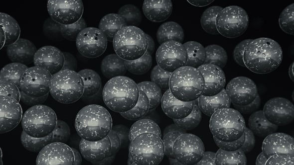 Floating Bowling Balls Against a Dark Background