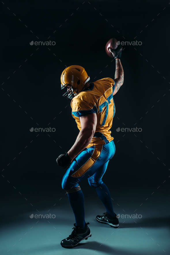American football player with ball in hand, NFL - Stock Photo - Images