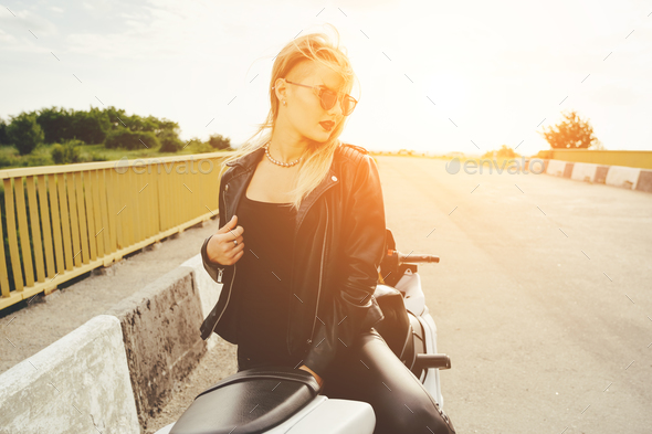 Biker girl in a leather clothes on a motorcycle