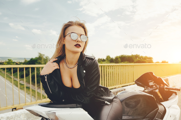 Biker girl in a leather clothes on a motorcycle Stock Photo by arthurhidden