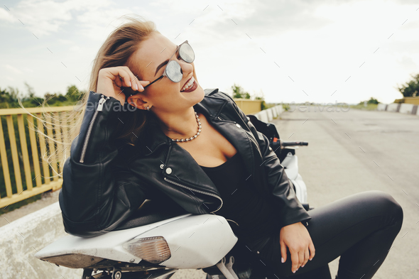 Biker girl in a leather clothes on a motorcycle