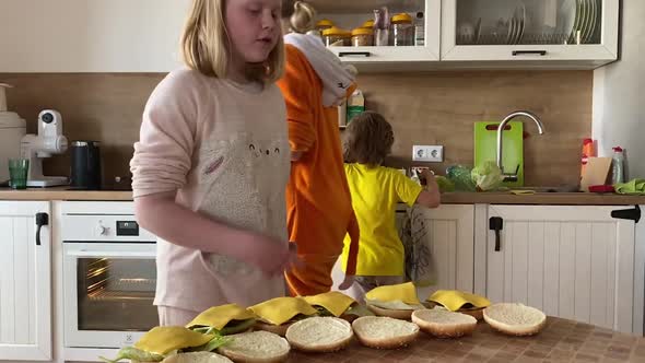 Mother with Children Prepares Burgers at Home in the Kitchen, Time Lapse