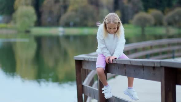 Portrait of Caucasian Pretty Small Girl with Blond Hair Smiling To Camera alt