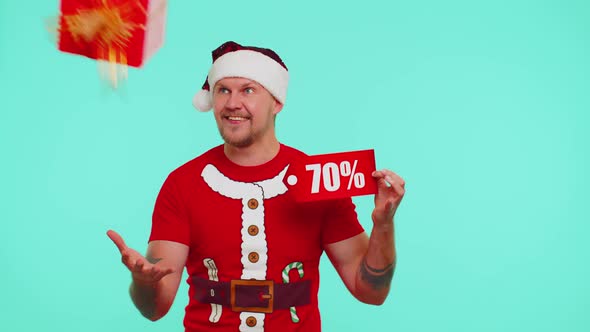 Man in Red Christmas Tshirt Showing Gift Box and 70 Percent Discount Inscriptions Banner Text Note alt