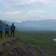 Drone Birds Eye View Four People Standing Top Peak Iceland Highlands Looking Stunning Panorama - VideoHive Item for Sale