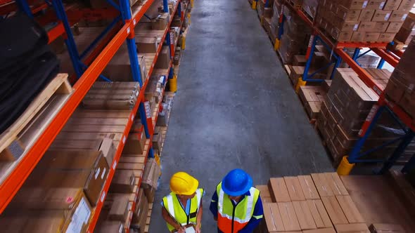 Warehouse worker working and interacting with each other alt