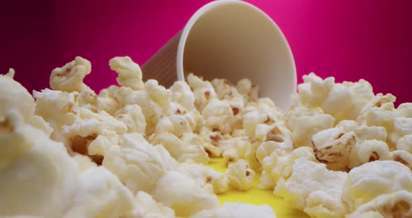 Macro Lens Closeup of Popcorn Scattered on the Table Travel on a Slider Along the Popcorn to a Glass alt