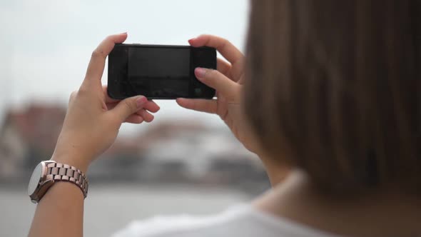 Asian woman using smartphone take photo.