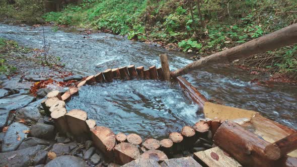The Mill Drives the Water in the River in the Autumn Forest in Cloudy Weather