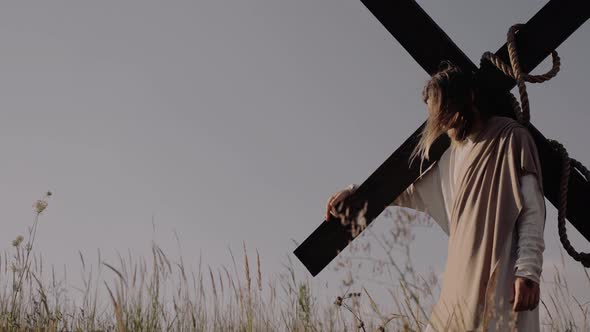 Jesus Stands with a Cross on His Shoulders, Stock Footage | VideoHive