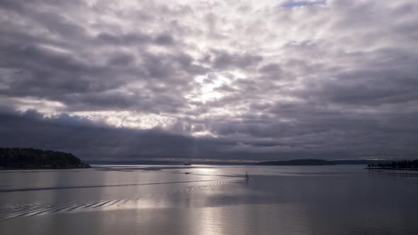 A coast guard ship passes through as low marine layer clouds sweep across, aerial hyperlapse alt