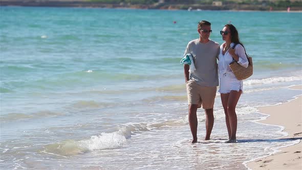 Young Couple on White Beach During Summer Vacation
