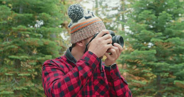 Forest Hiker Photographer in Woods. 30s Man Taking Pictures of Green Forest View alt