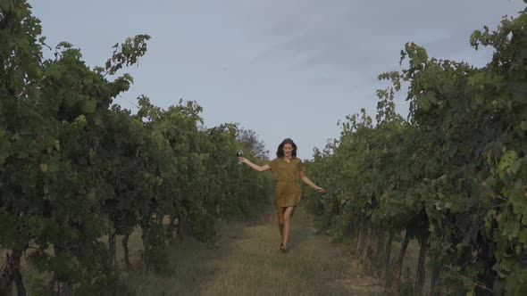 Happy Woman Run In Vineyard With Glass Of Wine