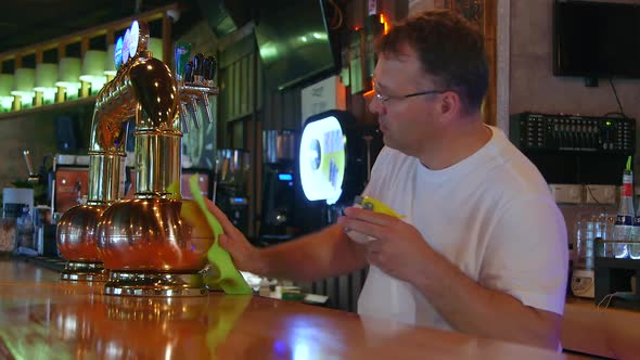 Bartender Cleaning the Bar.