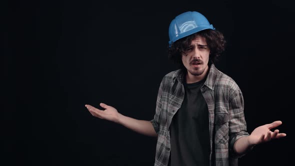 The Charismatic Hipster with the Blue Helmet of an Engineer Sees Something Unpleasant Wrinkles and alt