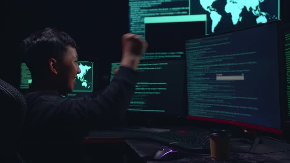 Asian Boy Hacker Using Multiple Computer Hacking And Success Downloading Data alt