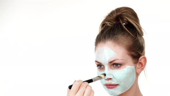 Girl Apply Green Mud Mask to Face