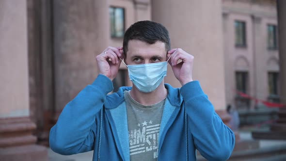 Man Takes Off His Medical Mask of Coronavirus Protection Outside and Smile