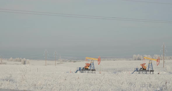 Two Oil Pumps in a Snow Field in General alt