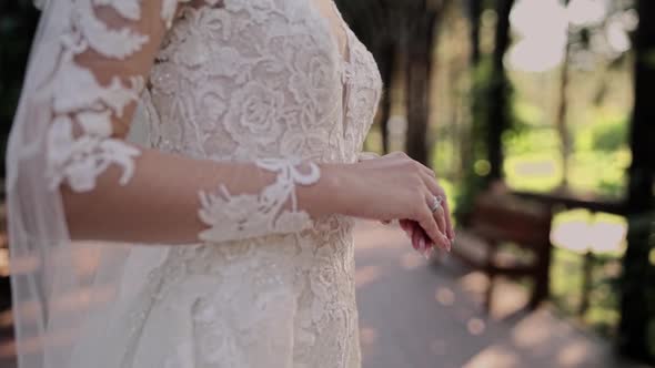 hands of the bride on a beautiful wedding dress