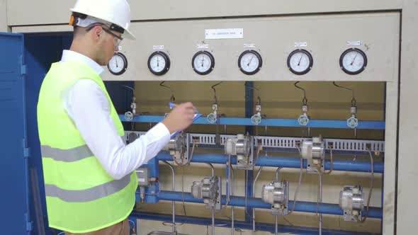 Engineer checking transducer rack at factory. alt