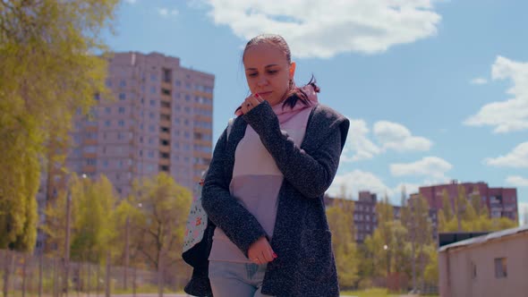 Close Up of Young Woman on Street in Sunny Weather alt